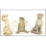 A group of three 20th Century composite stone garden statues to include a boxer dog, teddy bear