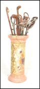 An early 20th Century stoneware stick stand together with a collection of four stick stands and