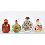 A group of four 20th Century Chinese snuff bottles to include three reverse painted bottles in the