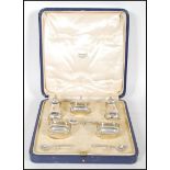 A cased Adie Brothers silver cruet set consisting of two pepperette's two table salts with blue