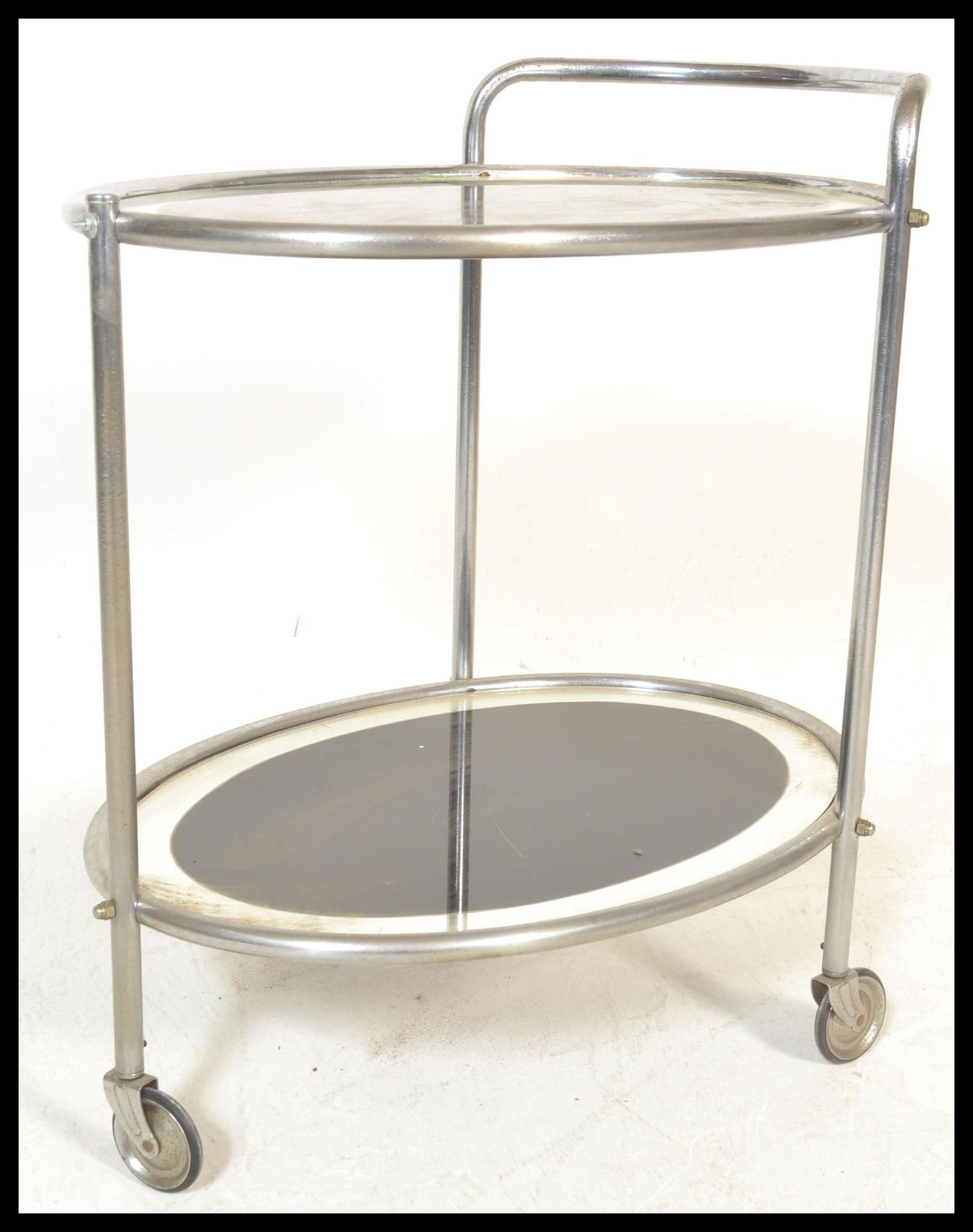 An early 20th Century Art Deco chrome and glass two tier drinks trolley. Each panel of oval form