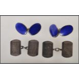 Two pairs of silver cufflinks one set being oval having blue enamelled front united by chains,