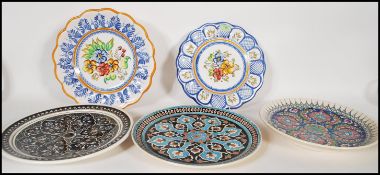 A collection of stoneware Moorish/ Spanish charger plates dating from the early 20th Century, each