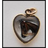 A reverse intaglio Essex crystal carved cabochon pendant of heart shape painted with a portrait of a