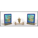 A pair of 20th Century Chinese brass bookends having enamelled panels with raised Chinese dragons