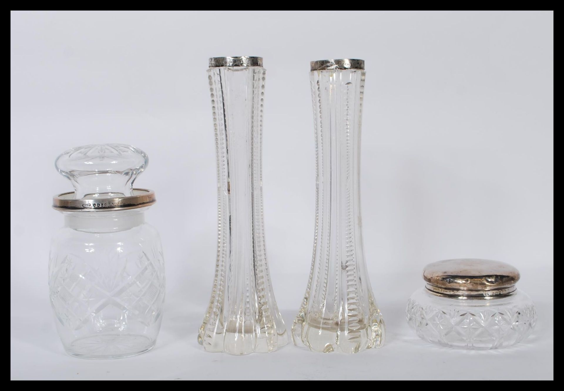 A pair of early 20th Century silver hallmarked and cut glass stem vases, hallmarked for Birmingham