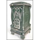 A large 20th century faux French painted green and silver upright pedestal room  heater in the