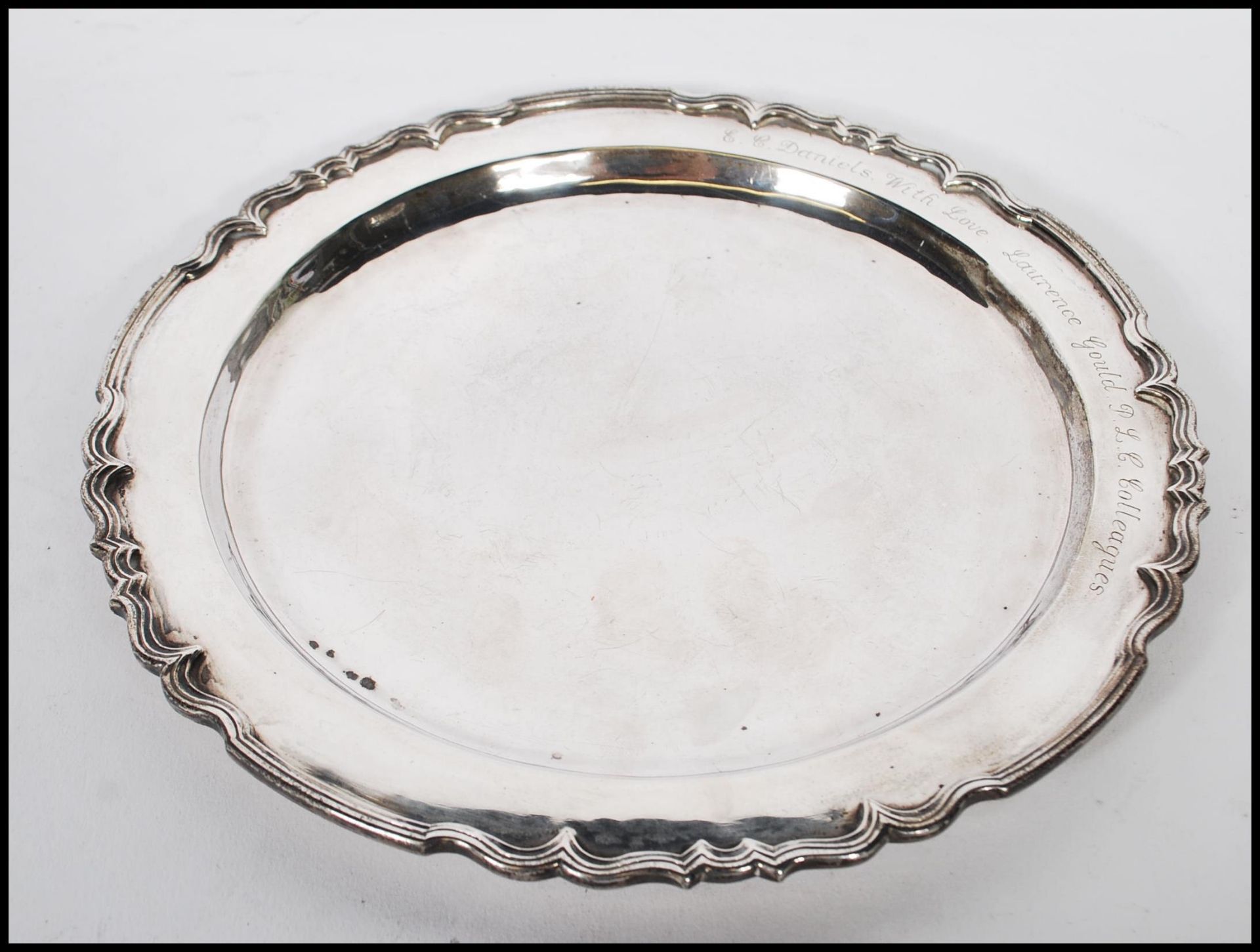 A silver hallmarked cabinet plate having decorative scrolled stepped rims. Hallmarked London 1988.