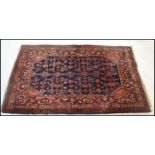 A 19th century Persian / Islamic Keshan rug with red and ble ground having geometric decoration with