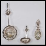 A collection of 3 large Dutch silver spoons to include a large example cast in relief with pierced