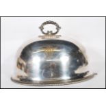A large 19th century Elkington & Co silver plated domed meat cover with monogram to the upper centre
