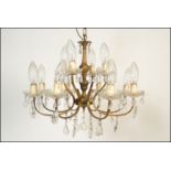 A six branch, twelve light gilt metal and cut glass chandelier, the sconces arranged in two tiers of