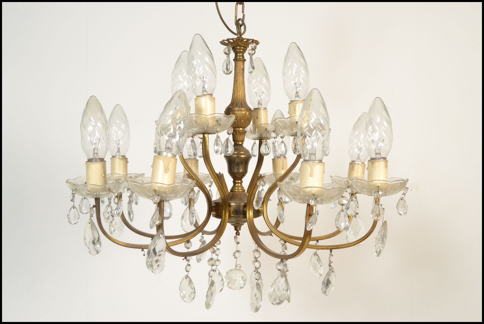 A six branch, twelve light gilt metal and cut glass chandelier, the sconces arranged in two tiers of