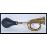 A early 20th Century vintage brass and rubber side mounted car horn in working order. Measures: 38cm