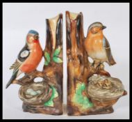 A pair of early 20th Century novelty ceramic book ends modelled as nesting birds in trees, one