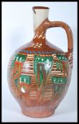 A 20th Century studio pottery ewer jug of bulbous