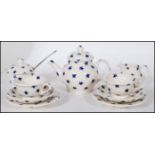 An Emma Bridgewater dollies tea set decorated with blue stars, consisting of two tea cups, two