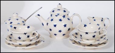 An Emma Bridgewater dollies tea set decorated with blue stars, consisting of two tea cups, two