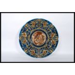 A 19th Century Austrian majolica Gebruder Schutz wall charger plate having a blue ground with relief