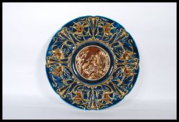 A 19th Century Austrian majolica Gebruder Schutz wall charger plate having a blue ground with relief