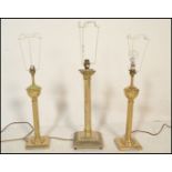 A pair of reeded column table lamps being of brass construction with neo classical doric columns
