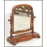 A 19th Century Victorian mahogany dressing table swing mirror of  arch form, raised on shaped base