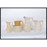 A group of four jugs to include a Doulton Lambeth stoneware style jug having drip glaze modelled