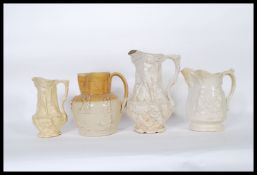 A group of four jugs to include a Doulton Lambeth stoneware style jug having drip glaze modelled