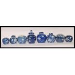 A collection of eight 18th / 19th Century Japanese ginger jars being hand painted in blue and