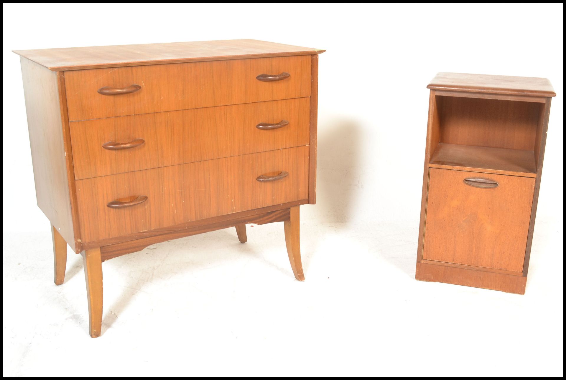 A retro 20th Century teak wood chest of three drawers, flared top raised on tapering supports,