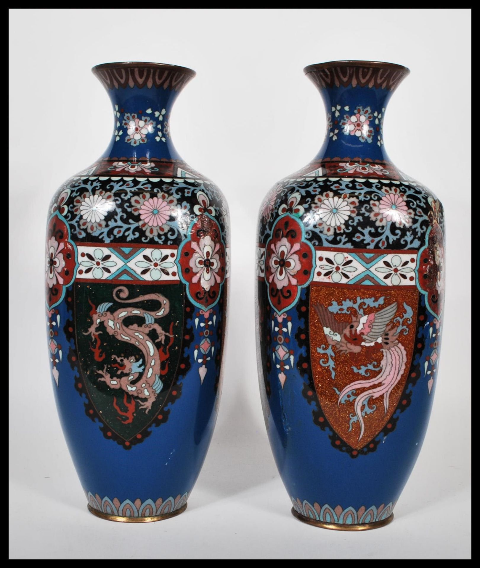 A pair of Japanese cloisonne vases of rounded square form having waisted flared rims, having