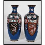 A pair of Japanese cloisonne vases of rounded square form having waisted flared rims, having