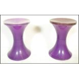 A pair of vintage 1960's Habitat Tam Tam stools in a purple tone colourway, the inverted body of the