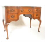 A good Queen Anne revival walnut serpentine fronted writing table desk. Raised on cabriole legs with