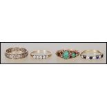 A collection of rings to include a stamped 375 pact gold ring set with two green stone cabochons and
