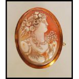 A 19th Century Victorian stamped 9ct gold shell cameo brooch of oval form. The brooch depicting a