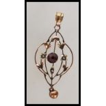 A 19th Century Victorian marked 9ct gold open work pendant set with seed pearls and a central