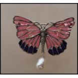 A silver stamped 925 plique a jour brooch in the form of a butterfly, 110the wings with pink and