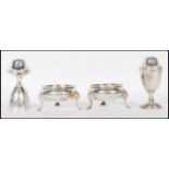 Two pairs of silver hallmarked pepperette and table salts condiments, the pepperettes on round