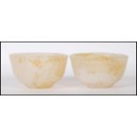 A pair of Chinese white jade bowls having applied brown mottled effect. Measures: 8cm diameter.