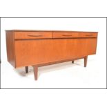 A retro 20th Century teak wood sideboard credenza of Danish inspiration, flared top over three