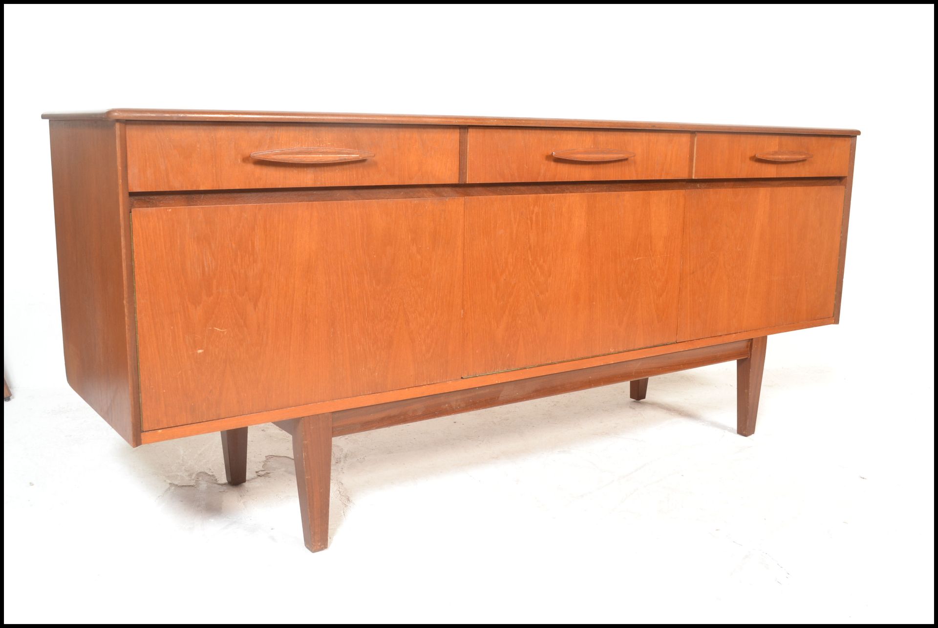 A retro 20th Century teak wood sideboard credenza of Danish inspiration, flared top over three