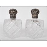 A pair of 19th Century Victorian silver hallmarked topped cut glass perfume bottles of octagonal