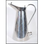 A 20th Century industrial farmers milk jug / churn having a chromed finish, lidded top and pouring