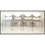 A set of eight panel stacking dining  chairs, the chairs panels having a silvered finish raised on