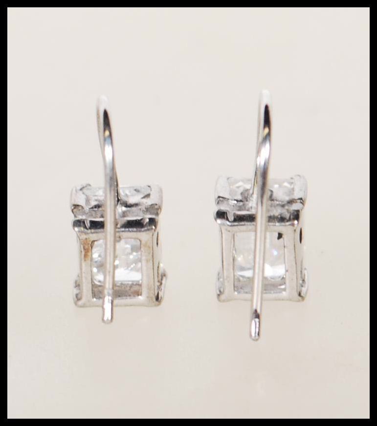 A pair of silver and emerald cut cz stone ladies earrings in claw mounts with hoop backs. Total - Image 3 of 3