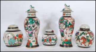 A pair of Chinese crackle glaze ceramic lidded vases decorated with warriors, the lids with foo