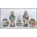 A pair of Chinese crackle glaze ceramic lidded vases decorated with warriors, the lids with foo