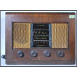 A vintage 20th Century walnut cased valve radio by Bush. Bush transfer logo to the top of the
