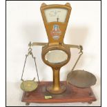 A set of vintage 20th Century shop grocery balance scales, gilt body with glazed dial to the top,